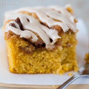 This Pumpkin Cinnamon Roll Cake is the most amazing cake ever! Serve it warm with the maple glaze!