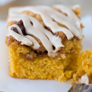 This Pumpkin Cinnamon Roll Cake is the most amazing cake ever! Serve it warm with the maple glaze!