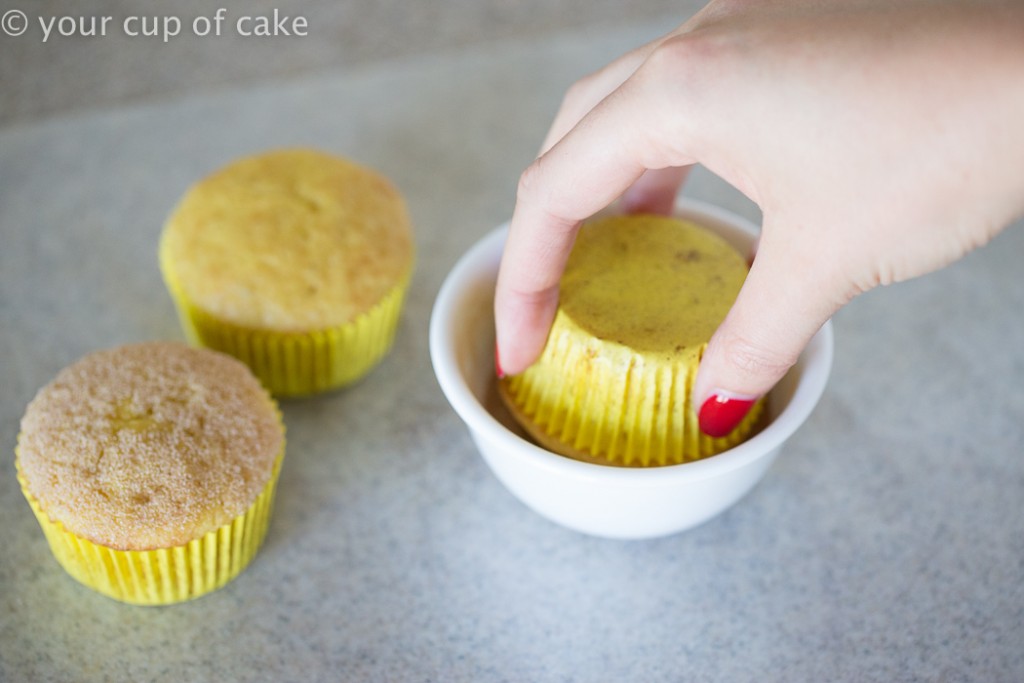 Rolling cupcakes in cinnamon sugar