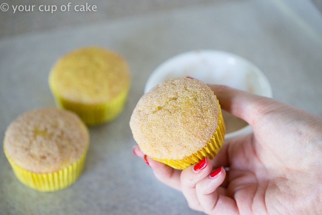 rolling cupcakes in cinnamon sugar