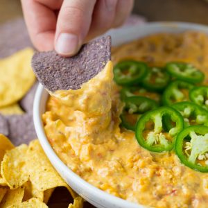 4 Ingredient Queso Dip made in the SLOW COOKER! Perfect for game day and parties